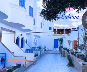 a walkway in a white building with a sign that reads ballaman at Balsam hotel in Dahab