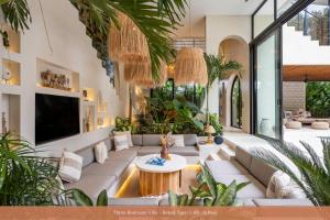 a living room with a couch and a table at Bebas Villas - Uluwatu, Bali in Uluwatu