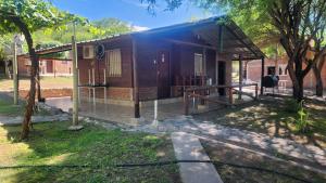 a small building with a porch and a tree at La Hueya in Coronel Moldes