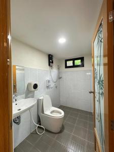 a bathroom with a toilet and a sink at Haad Salad Resort in Salad Beach