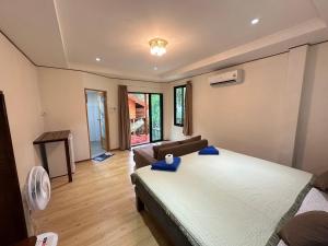 a bedroom with a bed and a couch in it at Haad Salad Resort in Salad Beach +45 photos