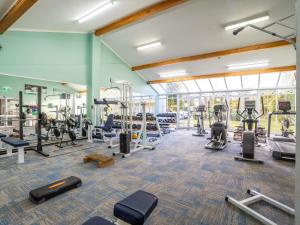 a gym with lots of treadmills and machines at Wairakei Resort Taupo in Taupo