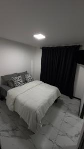 a bedroom with a bed and a black curtain at Departamento Pavones Beach Retreat in Pavones
