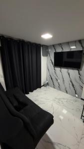 a room with a black curtain and a tv at Departamento Pavones Beach Retreat in Pavones