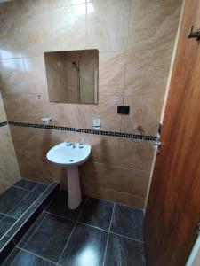 a bathroom with a sink and a mirror at Luluk, Casa de playa in Balneario Pehuén-Có +23 photos