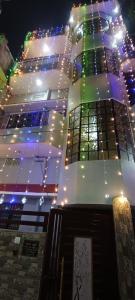 a tall building with christmas lights on it at Bajrang kutir 17 in Varanasi