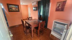 a dining room with a table and chairs and a fireplace at La Hueya in Coronel Moldes