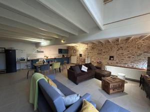 a large living room with couches and a kitchen at Gîte de Charme avec Jardin, Wifi et Parking à Saint-Gourson - FR-1-653-285 in Saint-Gourson