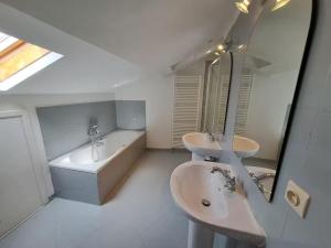 a white bathroom with two sinks and a bath tub at Gîte de Charme avec Jardin, Wifi et Parking à Saint-Gourson - FR-1-653-285 in Saint-Gourson +10 photos