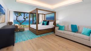 a living room with a bed and a couch at ❤PiH❤ Hapuna Beachfront Bliss Beachfront Steps From Ocean B29 in Hapuna Beach +47 photos