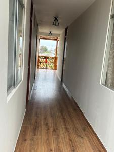 an empty hallway with wood floors in a house at Flamante atardecer in San Antonio