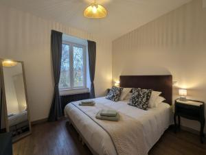 a bedroom with a large bed and a large window at Les champs dessus in Sarrey