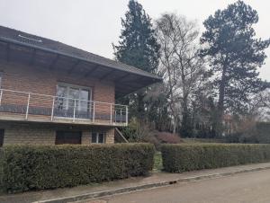 a house with a balcony on the side of it at Les champs dessus in Sarrey