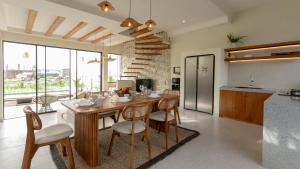 a kitchen and dining room with a table and chairs at Casa Amani 3BR Mediterranean w Pool Near Seminyak in Kerobokan +35 photos