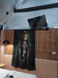 a curtain with a picture of a man wearing a crown at Two crazy monkeys in Bakjawan +59 photos
