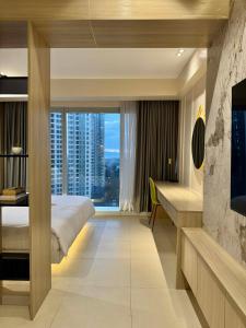 a hotel room with a bed and a large window at Aeon Towers Davao Condotel near Abreeza Ayala Mall in Davao City