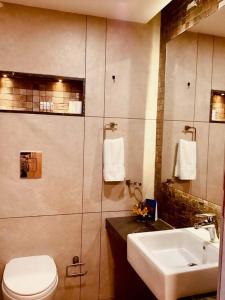 a bathroom with a toilet and a sink at Mountain Retreat Kodai in Kodaikānāl +79 photos