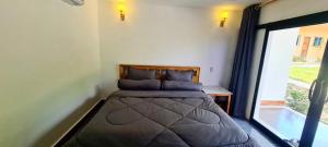 a bed in a room with a large window at Koh Rong Lagoon in Koh Rong Island