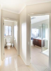 a bathroom with a toilet and a sink at Popular Grand Villa Shepparton in Shepparton +27 photos