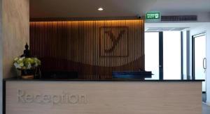 a lobby with a reception desk with flowers on it at The Y House in Chiang Mai