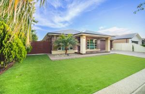 a house with a green lawn in front of it at Popular Grand Villa Shepparton in Shepparton