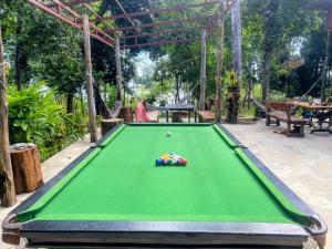 a green pool table with a cue ball on it at Koh Rong Lagoon in Koh Rong Island