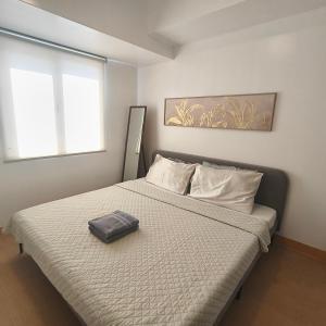 Centrio Tower Condo Units في كاغايان دي أورو: غرفة نوم عليها سرير مع كيس