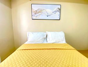 Centrio Tower Condo Units في كاغايان دي أورو: سرير في غرفة مع صورة على الحائط +3 صور