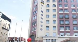 a tall building with a sign on the side of it at Best Western Tianjin Juchuan Hotel in Binhai