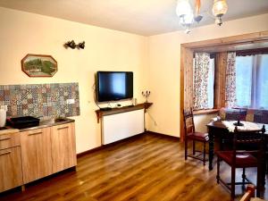 a living room with a flat screen tv and a table at Dom Karpacz -Wolna in Karpacz