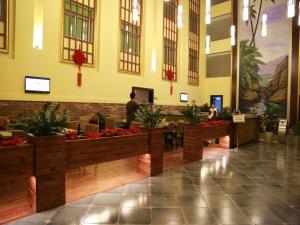 a lobby of a hotel with people sitting at tables at Fuzhou Chuanjie Hotspring and Golf Club Hotel in Fuzhou +268 photos