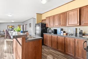 uma grande cozinha com armários de madeira e um frigorífico em The Country Haven em Huntsville mais 17 fotografias