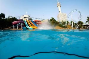 a water park with a water slide and a roller coaster at Sea beach Koh Larn 2 Hotel in Ko Larn
