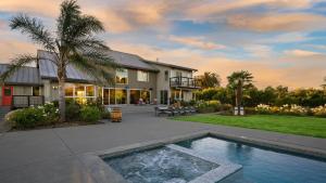 a house with a swimming pool in front of a house at Coplan Vineyards by AvantStay 10-Acre Estate w Pool Spa Bocce Designer Interiors in Sonoma