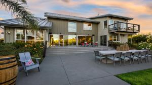 a house with a patio and a table and chairs at Coplan Vineyards by AvantStay 10-Acre Estate w Pool Spa Bocce Designer Interiors in Sonoma