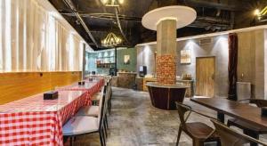 a restaurant with tables and chairs in a room at James Joyce Coffetel Qufu Tourist Center Gulou Street Sankong Scenic Spot in Qufu