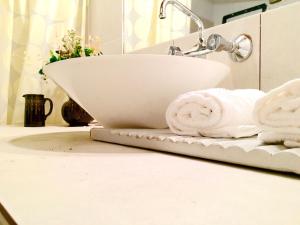 a white bathroom sink on a counter with towels at Casa Buika in Tilcara +16 photos