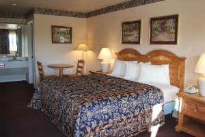 a hotel room with a bed and a bathroom at Lakeside Inn & Suites in Mathis