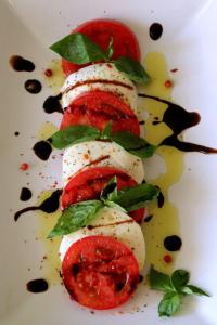 a plate of food with tomatoes and sauce at Departamento Pavones Beach Retreat in Pavones