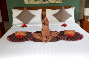 a bed with towels and robes on top of it at Dolce Magia in Gili Trawangan +51 photos