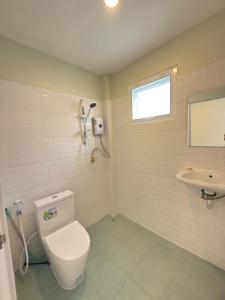 a bathroom with a toilet and a sink at Bright Sanctuary in Ko Phangan