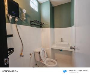 a bathroom with a toilet and a sink at The loft hotel Betong in Betong