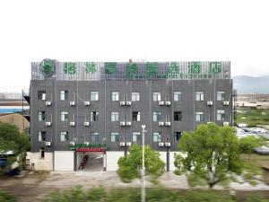 a large gray building with a green and white at GreenTree Inn Linhai Jiangnan Avenue Express in Linhai