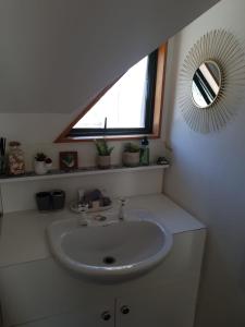 a bathroom with a sink and a mirror and a window at Remarkable studio,close to airport in Queenstown