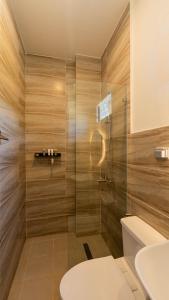 a bathroom with a shower with a toilet and a sink at Dono Pool Villa & Spa in Dauis +41 photos