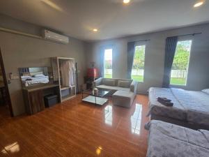 a living room with a couch and a table at Chaba4 in Ban Nong Bua Noi
