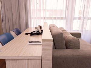 ein Holztisch mit einer Couch und einem Telefon darauf in der Unterkunft Mercure Recife Navegantes in Recife + 38 Fotos