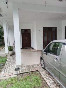 a car parked in front of a house at Bosadi Apartment katunayaka in Katunayake