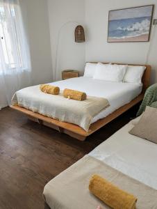 a bedroom with a bed with two towels on it at Private Garden Studio - Walk to Beach in Byron Bay