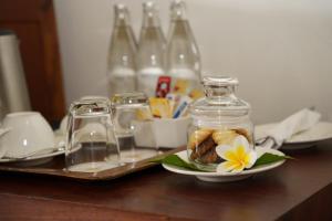 a plate with a flower in a jar on a table at Luang Prabang View Hotel in Luang Prabang